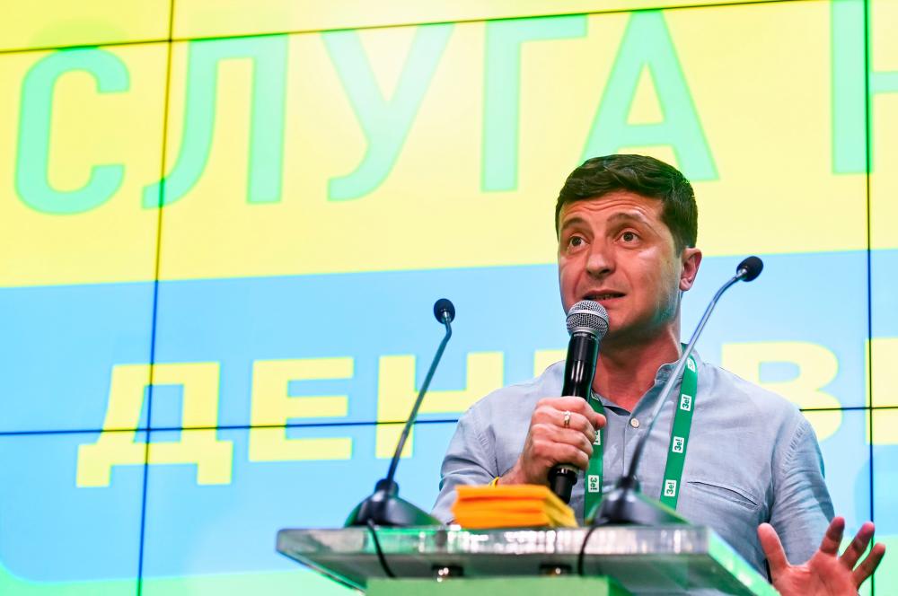 Ukrainian President Volodymyr Zelensky gives a speech at his Servant of the People party’s election headquarters in Kiev on July 21, 2019, after Ukraine’s parliamentary election. — AFP