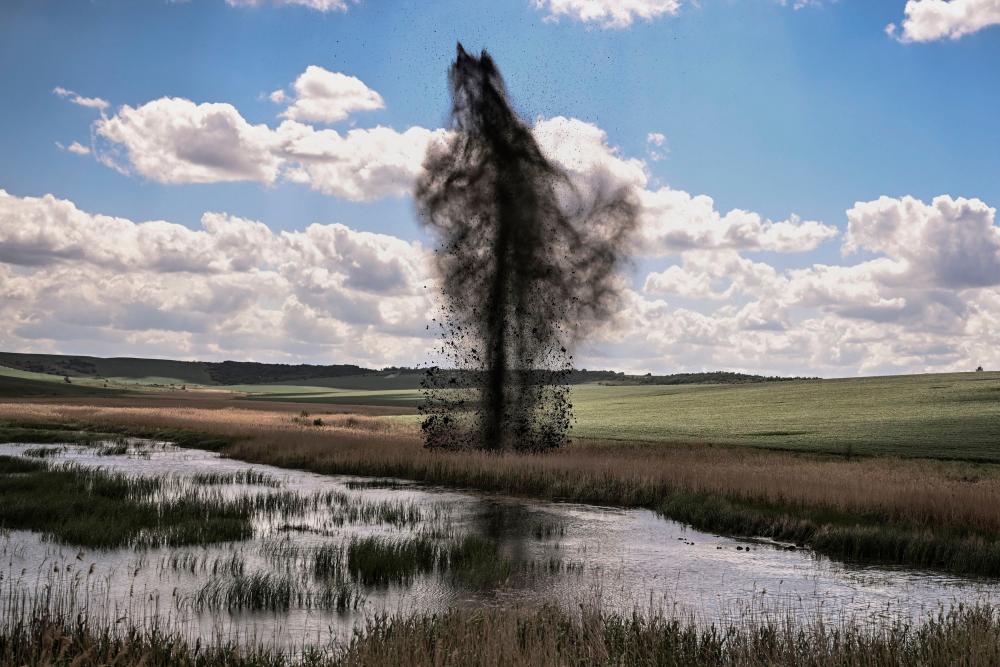 A mortar explodes next to the road leading to the city of Lysychansk in the eastern Ukranian region of Donbas, on May 23, 2022, amid Russian invasion of Ukraine. AFPPIX
