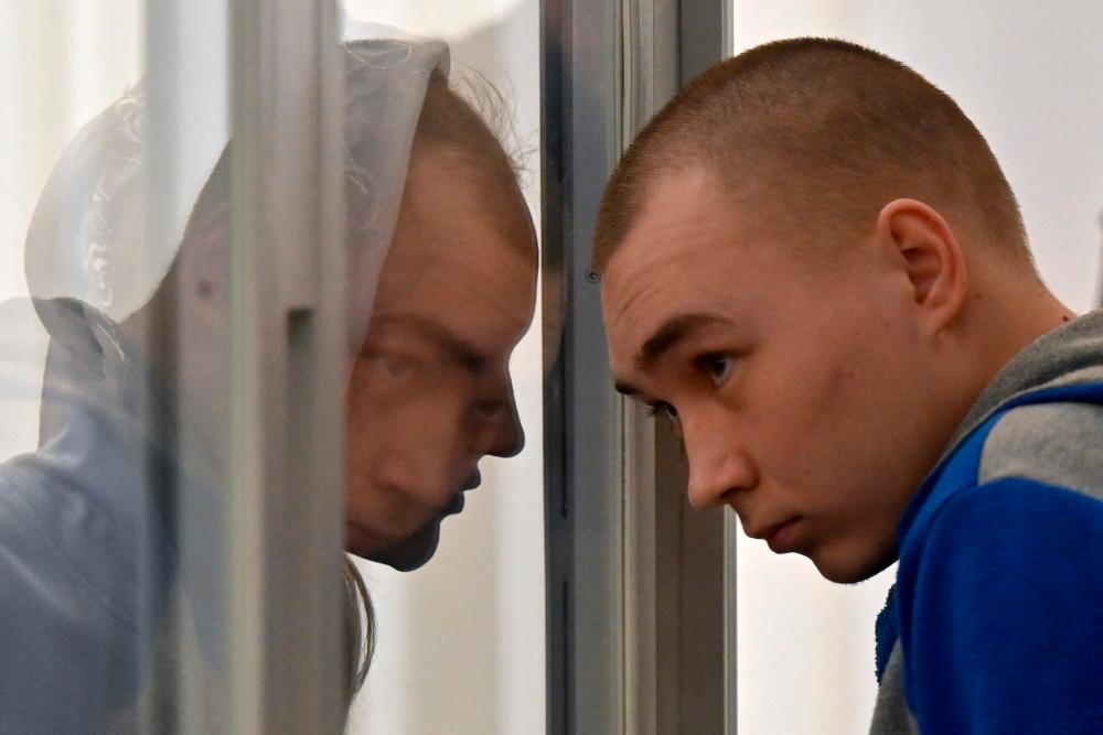 Russian sergeant Vadim Shishimarin listens court sentence in the defendant’s box on the last day of his trial on charges of war crimes for having killed a civilian, at a courthouse in Kyiv on May 23, 2022. AFPPIX
