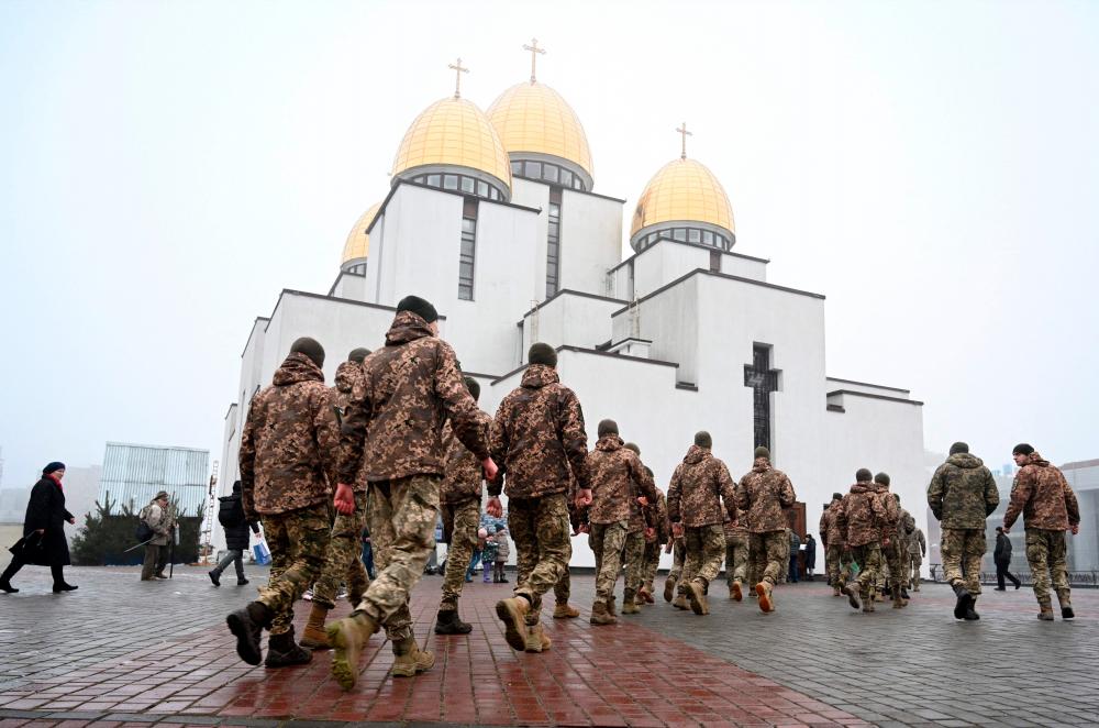 Ukrainian cadets walk in front of the Nativity of the Holy Virgin Church in western Ukrainian city of Lviv, on January 22, 2023, on the Day of Unity of Ukraine. AFPPIX