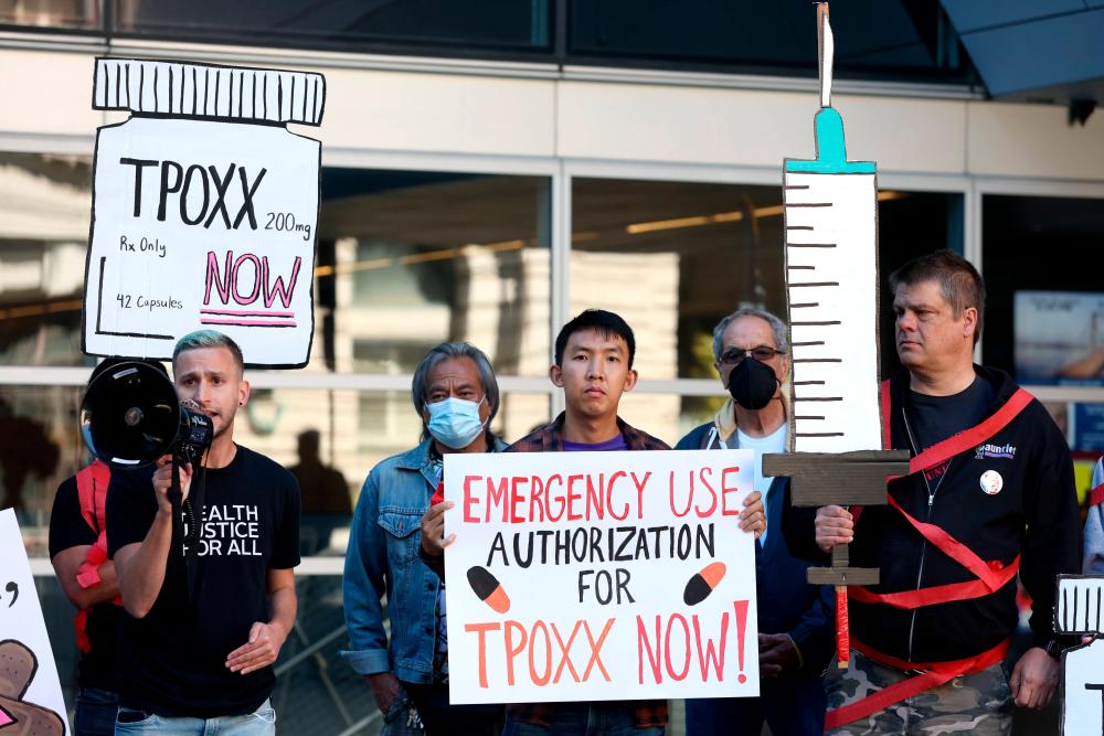 SAN FRANCISCO, CALIFORNIA - AUGUST 08: Healthcare and LGBTQ rights activists holds signs as they stage a protest outside of the San Francisco Federal Building on August 08, 2022 in San Francisco, California. AFPPIX
