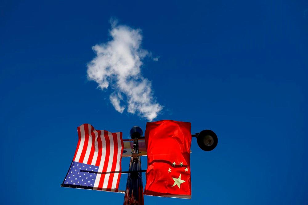 The flags of the United States and China fly from a lamppost in the Chinatown neighborhood of Boston, Massachusetts, U.S., November 1, 2021. REUTERSpix