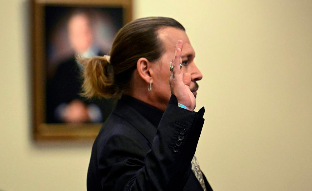 US actor Johnny Depp is sworn in during his defamation trial in the Fairfax County Circuit Courthouse in Fairfax, Virginia. - AFPpix