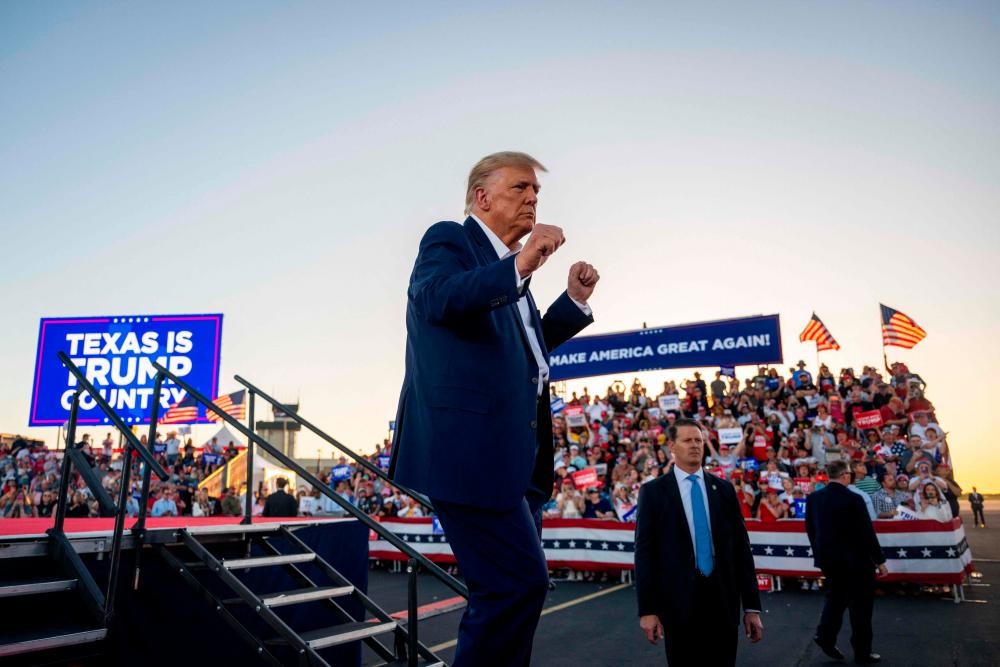 WACO, TEXAS - MARCH 25: Former U.S. President Donald Trump dances while exiting after speaking during a rally at the Waco Regional Airport on March 25, 2023 in Waco, Texas. AFPPIX
