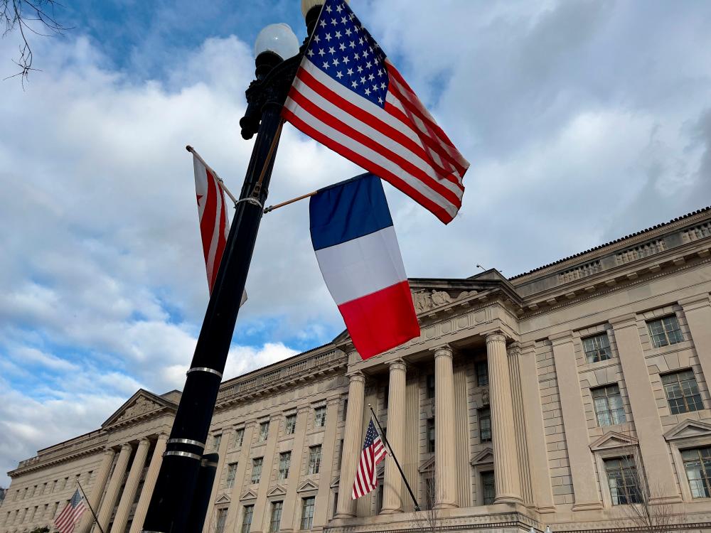 A United States, French and District of Columbia flag are seen flying near the White House, in Washington, DC on November 28, 2022 in preparation for the French President Emmanuel Macron state visit on Tuesday. AFPPIX