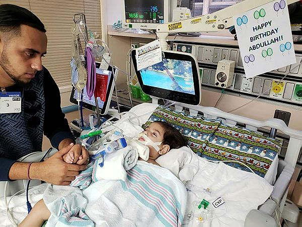 This photo courtesy of the Council on American-Islamic relations in Sacramento shows the young Abdullah Hassan on life support at UCSF Benioff Children’s Hospital in Oakland on Dec 16, 2018 with his father, Ali. — AFP