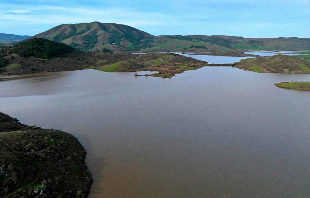 In an aerial view, the Nicasio Reservoir is seen at 100 percent capacity after a series of atmospheric river events drenched Northern California on January 12, 2023 in Nicasio, California/AFPPix