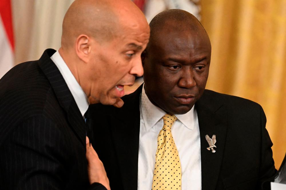 US Senator Cory Booker (D-NJ) and US attorney Ben Crump speak prior to a signing ceremony in the East Room of the White House in Washington, DC, on May 25, 2022. US President Joe Biden is expected to sign an Executive Order to advance policing and strengthen public safety. AFPPIX