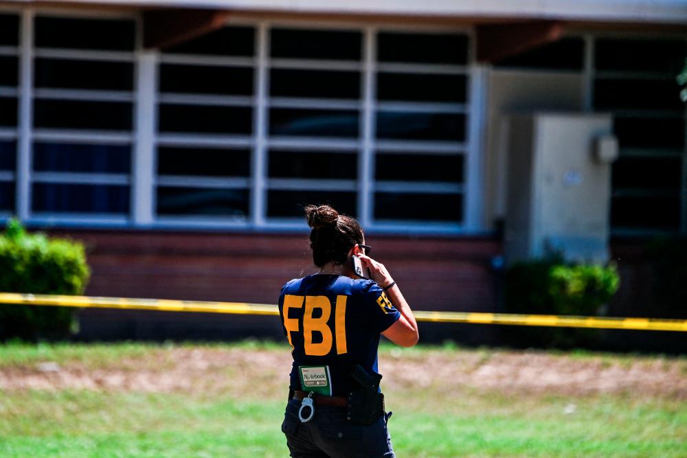 An FBI agent is seen outside Robb Elementary School in Uvalde, Texas, on May 25, 2022. AFPPIX