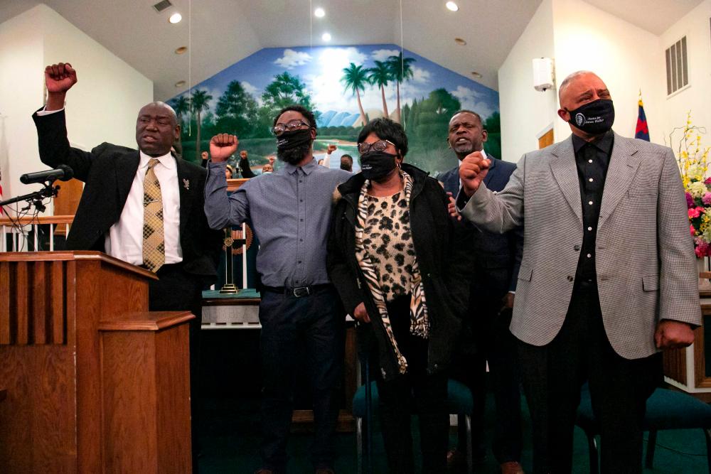 Attorney Ben Crump (L), alongside the family of Jason Walker, including his brother, mother Janice Walker (C), and father, Anthony Walker (R), attend a news conference on January 13, 2022, in Fayetteville, North Carolina. Jason Walker was shot and killed by off-duty officer, Jeffrey Hash, on January 8, 2022, in Fayetteville. AFPPix