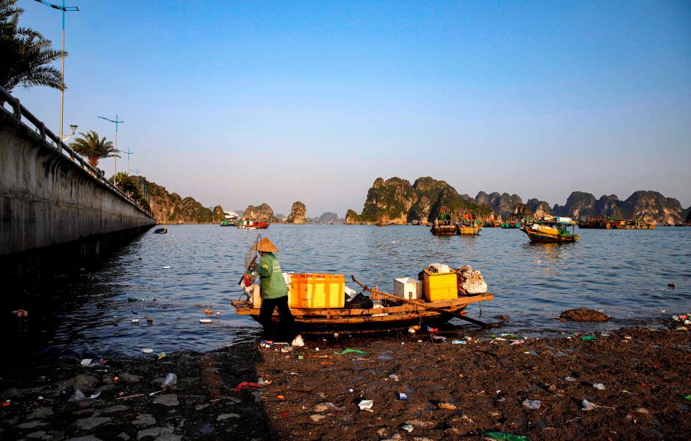 This photo taken on May 17, 2023, shows workers picking up trash from Ha Long Bay in northeast Vietnam/AFPPix