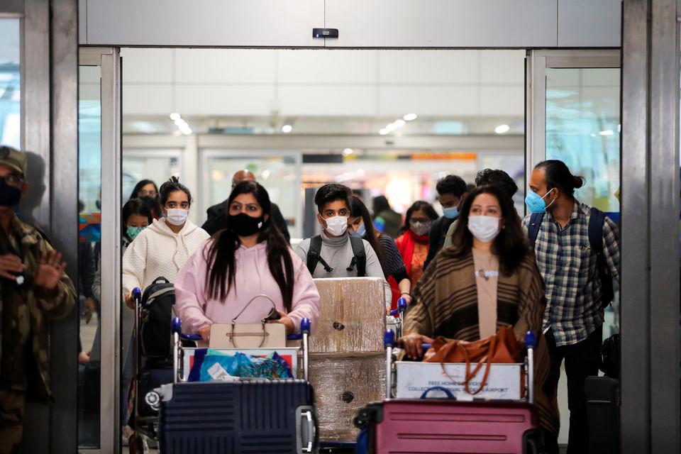 People exit from the arrival section of the Indira Gandhi International Airport in New Delhi, India, December 3, 2021. REUTERSpix