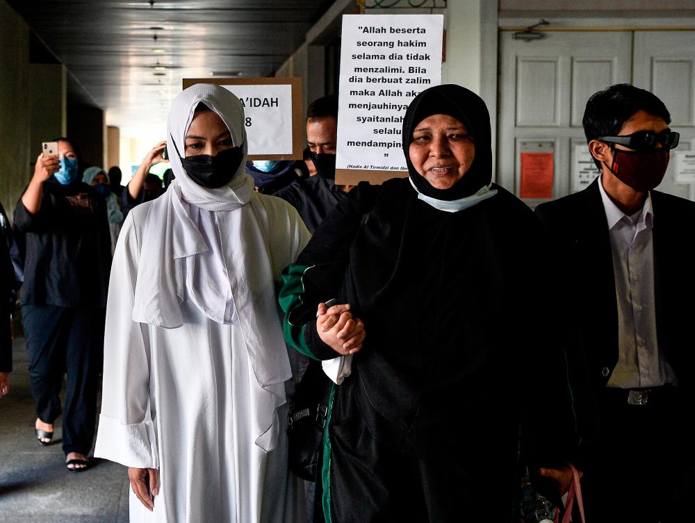 Emilia (left) at the syariah court in Kuala Lumpur on Monday. Her seven-day prison sentence caused an uproar among the public and non-governmental organisations. – BERNAMAPIX