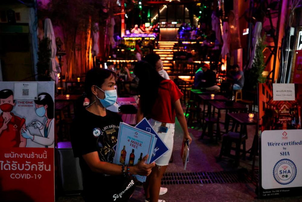 A waitress waits for customers at a restaurant in Khaosan Road, one of the favourite tourist spots, as Thailand bans entry from eight African countries over the coronavirus Omicron variant, in Bangkok, Thailand, November 30, 2021. REUTERSpix