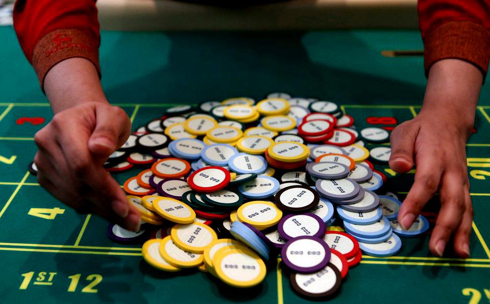 A casino dealer collects chips at a roulette table in Pasay city, Metro Manila, Philippines, March 27, 2015. REUTERSPIX